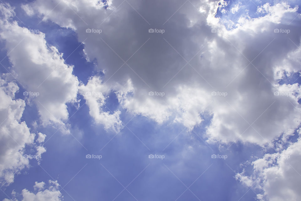 The beauty of the sky with clouds and the sun in summer.