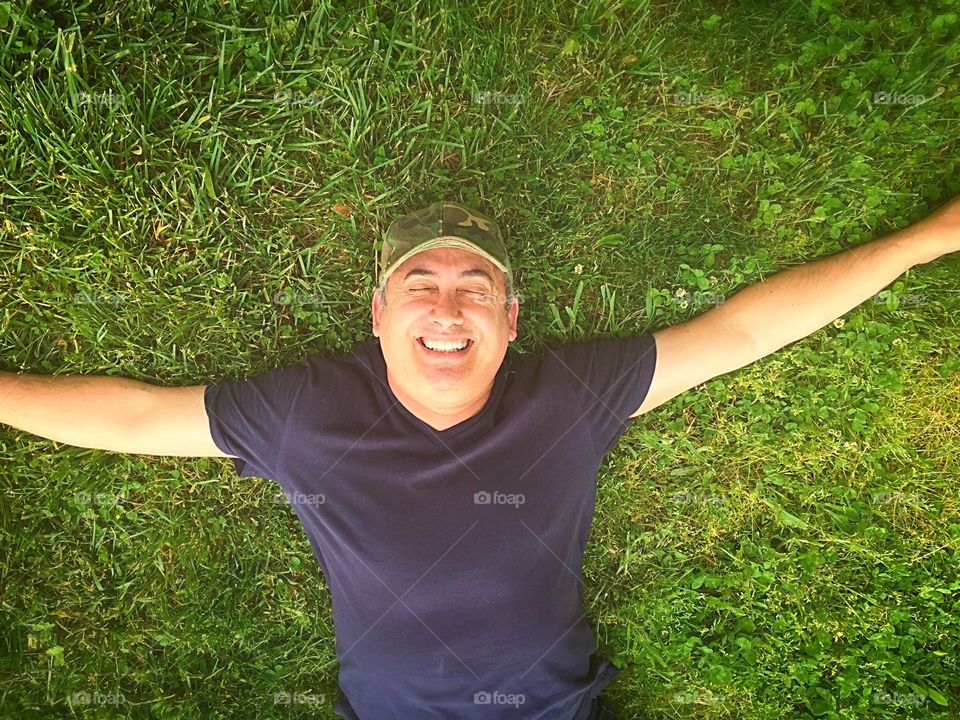 Happy moment—man smiling on grass 