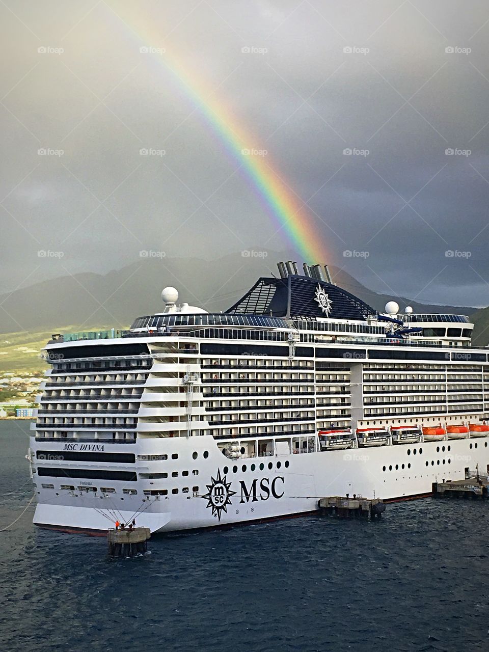 Beautiful double rainbow during a rainstorm.  It looks like it’s going right into the cruise ship in port at St. Kitts.