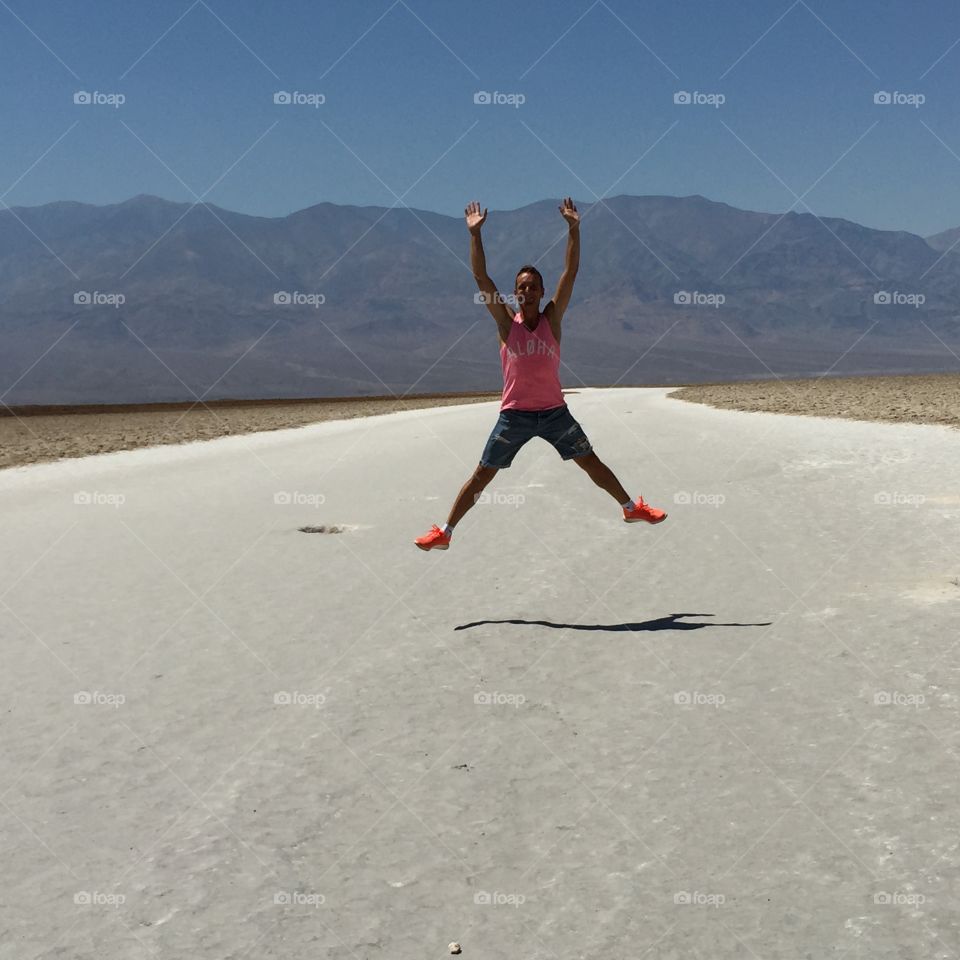 Young man jumping on empty street