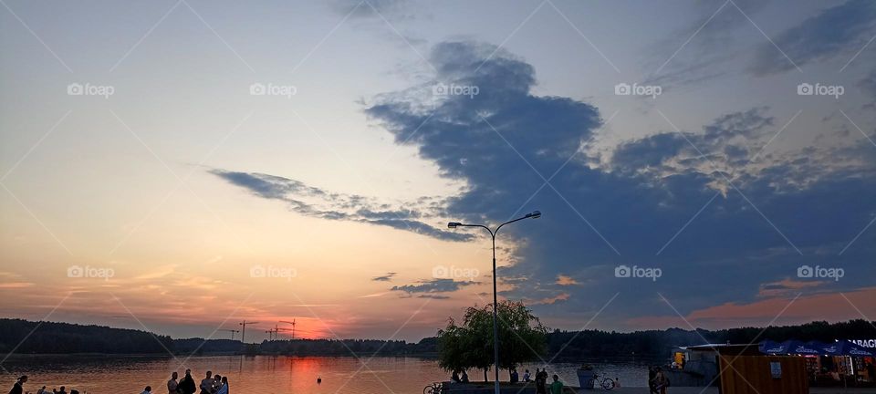 people on a lake, evening sunset,summer in the city