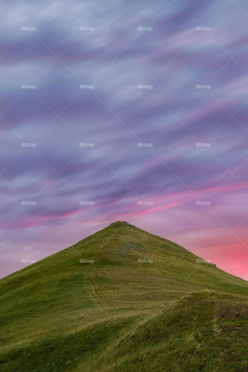 Scenic view of mountain against sky during sunset.