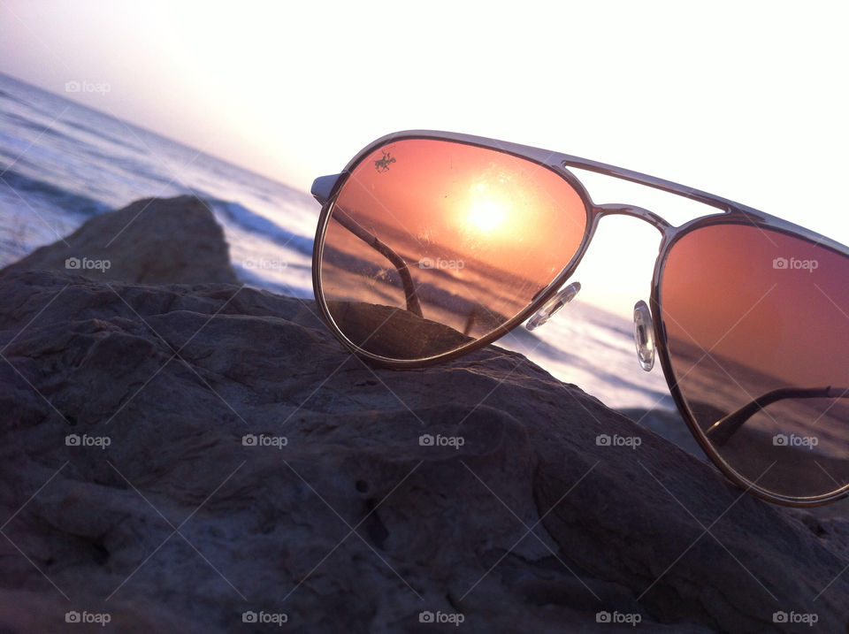 My girl friend's glasses on a rock in tel aviv sea in sunset. 🌅
