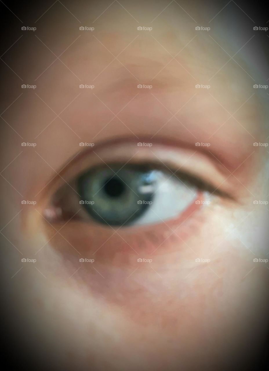 blue eye with yellow ring of a girl watching  TV