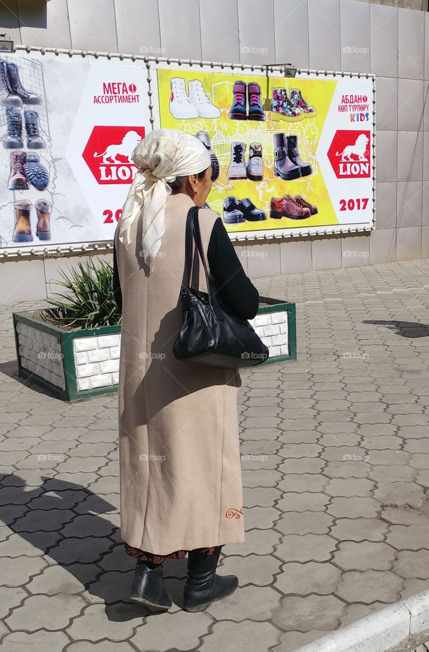 It's a simple shot of a woman walking on a street. End of story. 