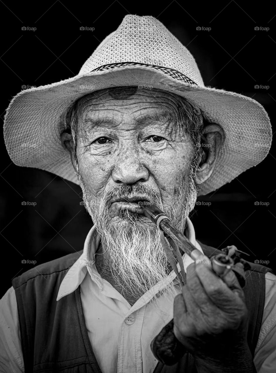 Photo of the years,people,old grandfather is smoking 