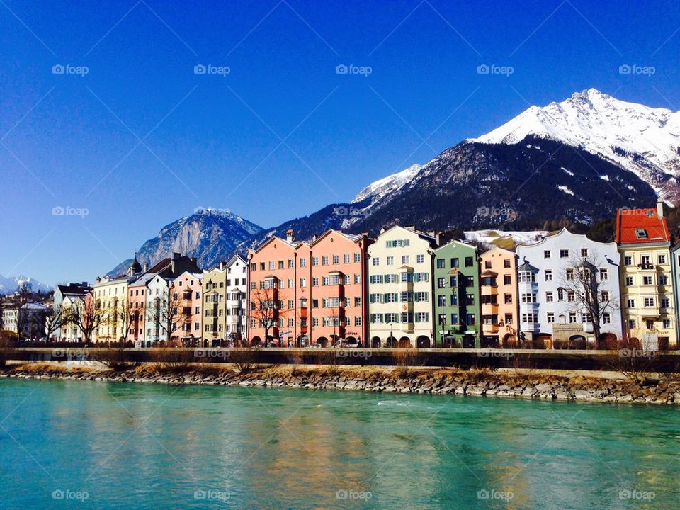 colorful houses riverside with snow mountains background 