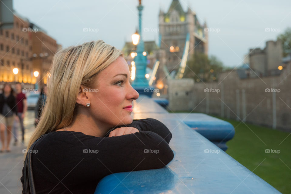 Close-up of blonde woman looking at city