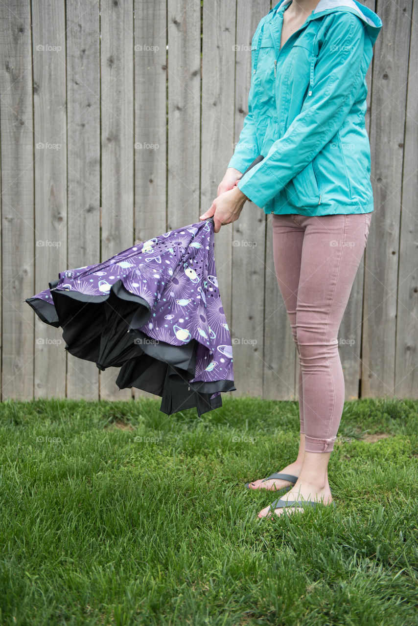Woman opening an umbrella outdoors