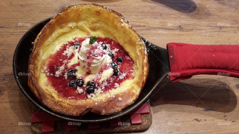 Ice cream in crepe pan with berries