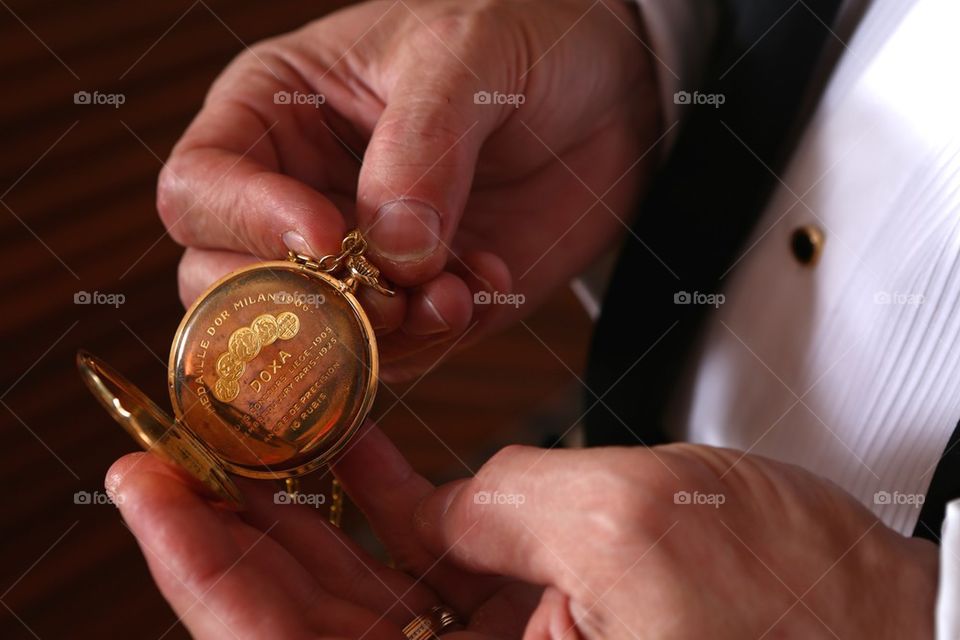 Pocket watch in gentlman's hands
