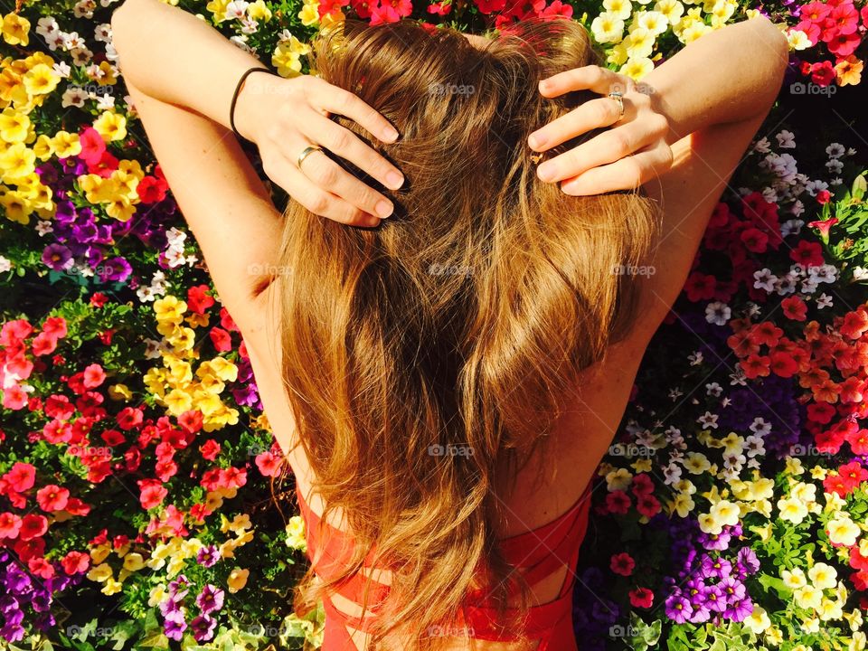 Rear view of woman standing against the flower