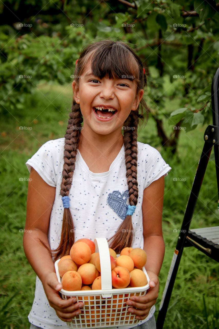 Happy girl with apricots