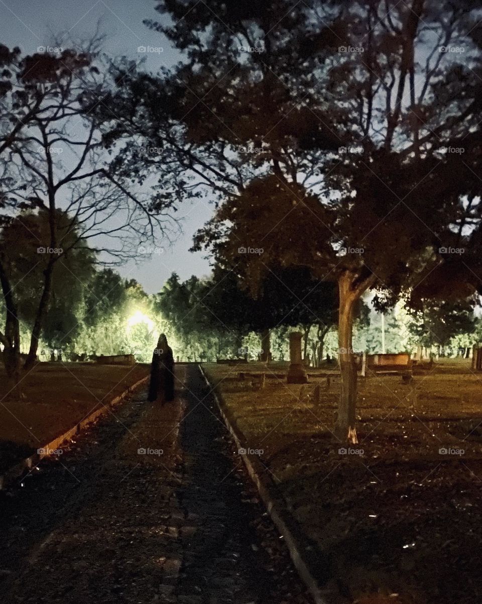 Cloaked figure in graveyard 