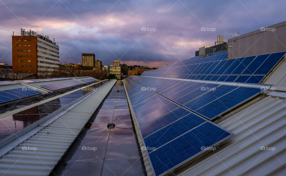 Solar panels on rooftop . Banks of solar panels on rooftop of a building 