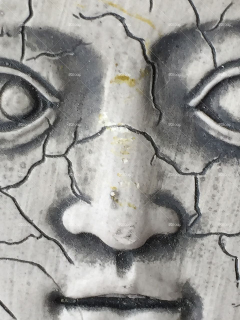 Close up face in cement.