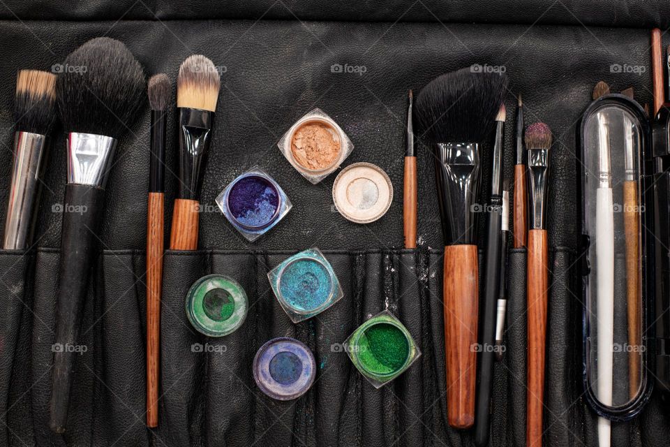 Set for professional make-up.  Brushes, shadows, glitter and mascara. Beautician job