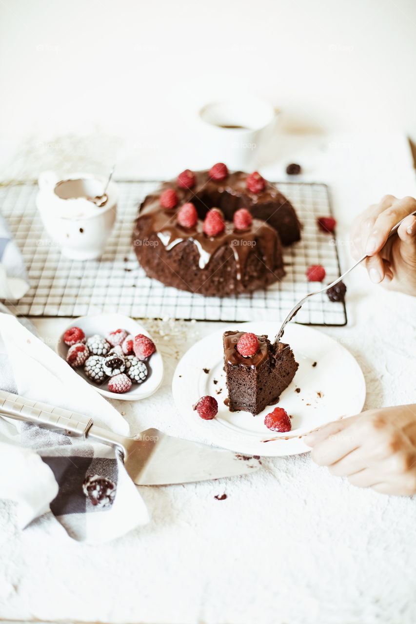 a piece of chocolate cake/brownie with chocolate mousse and raspberry on the top food photography
