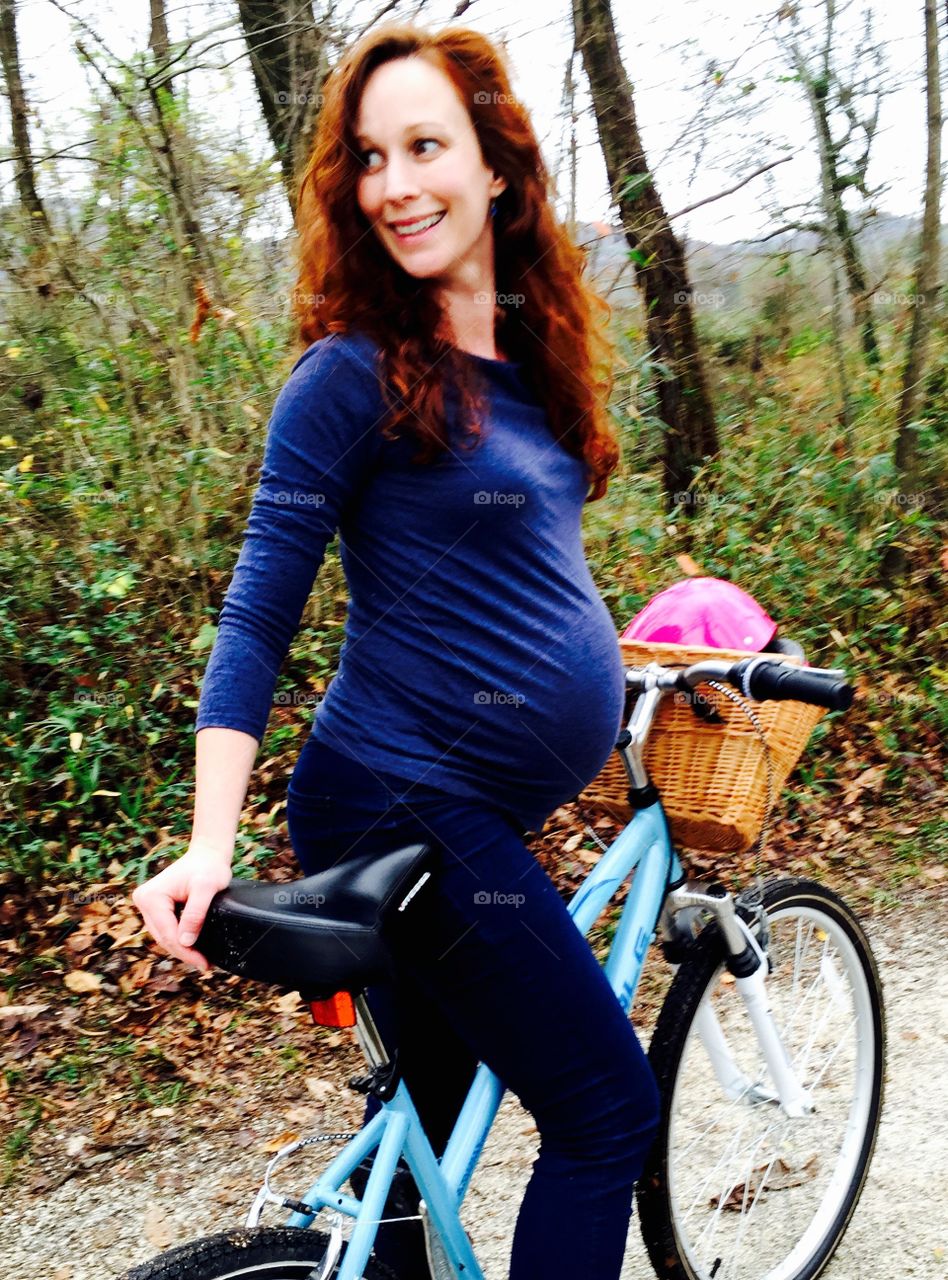 Portrait of young woman on bicycle