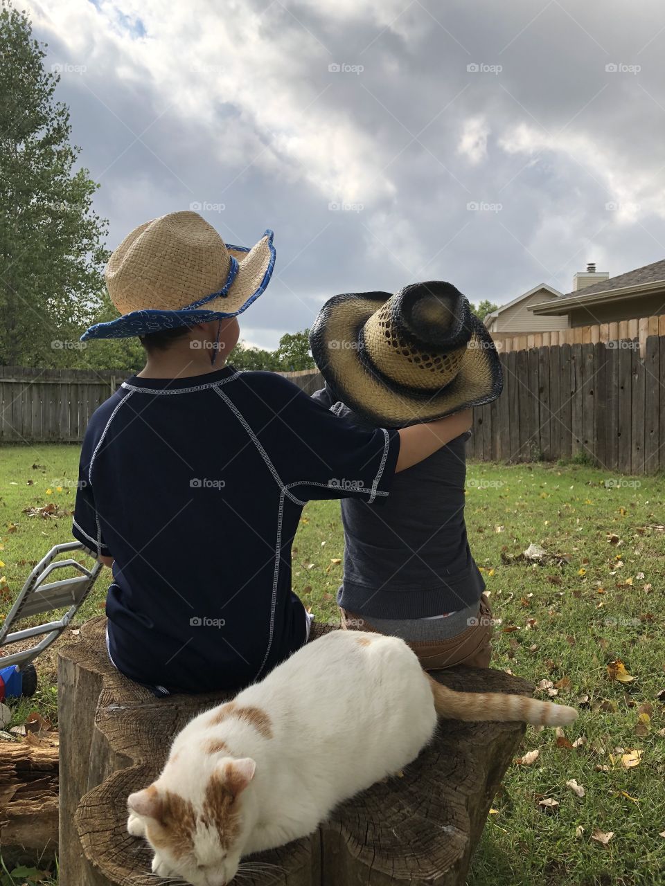 Little boys dressed as co boys enjoying the day. 