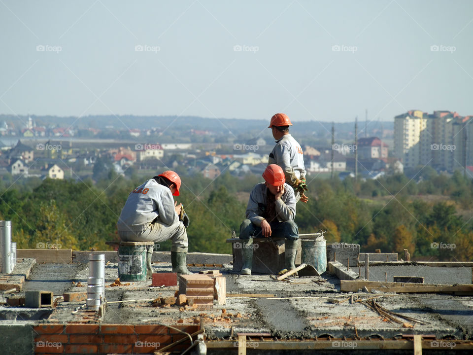 Waiting. Construction Workers on building