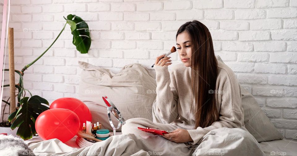 woman using cosmetics at home