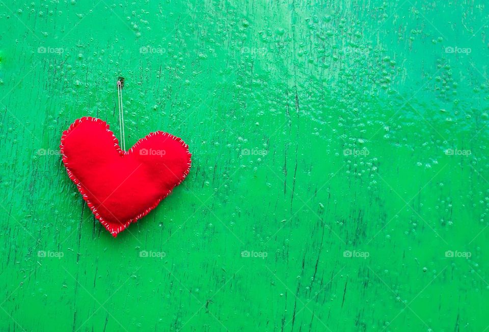 Red heart hanging on wall