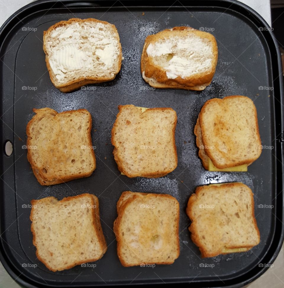 cheese sandwich grilling on a non-stick pan