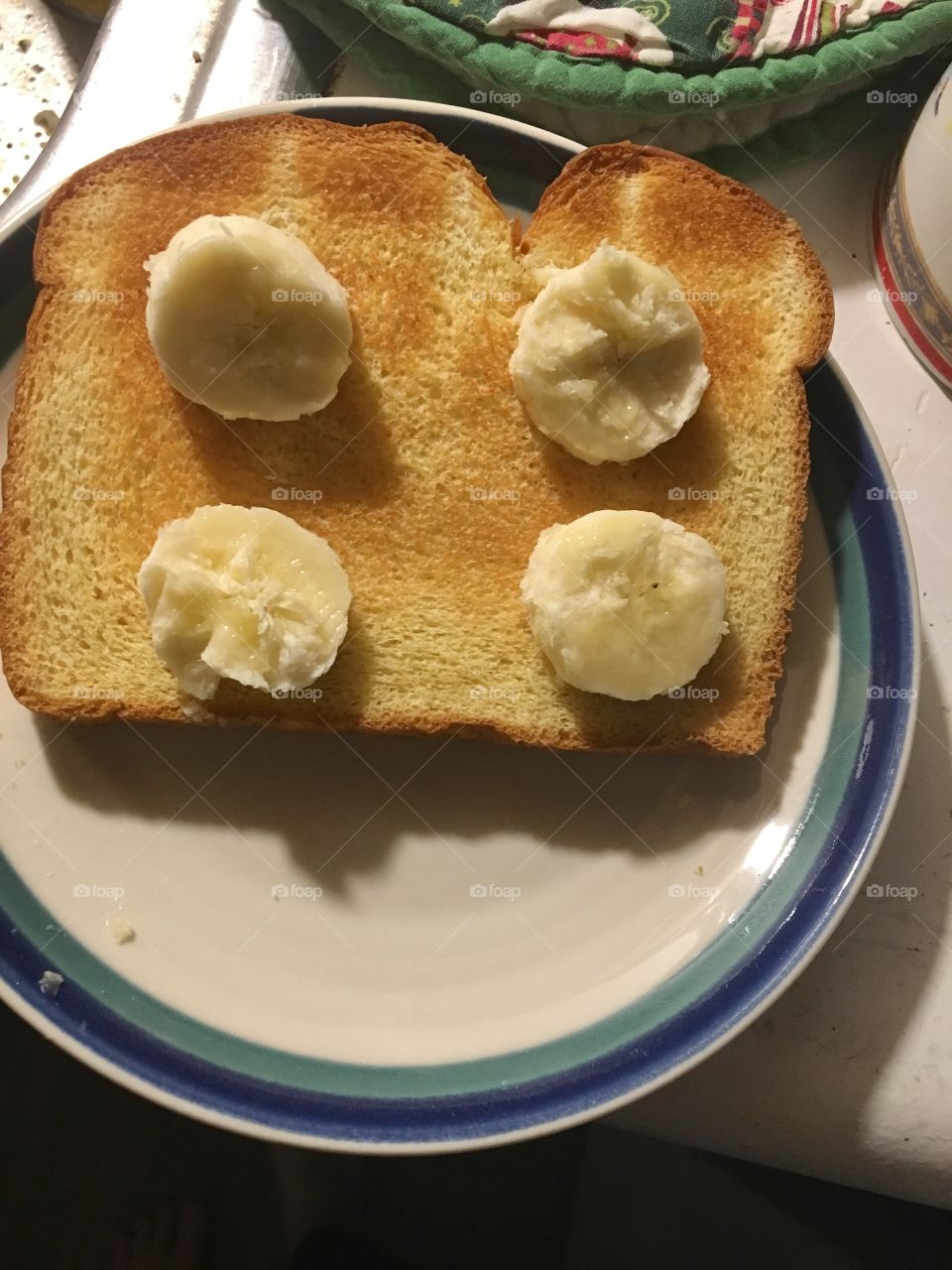 Golden toast with banana slices, on the kitchen counter ready-to-eat.