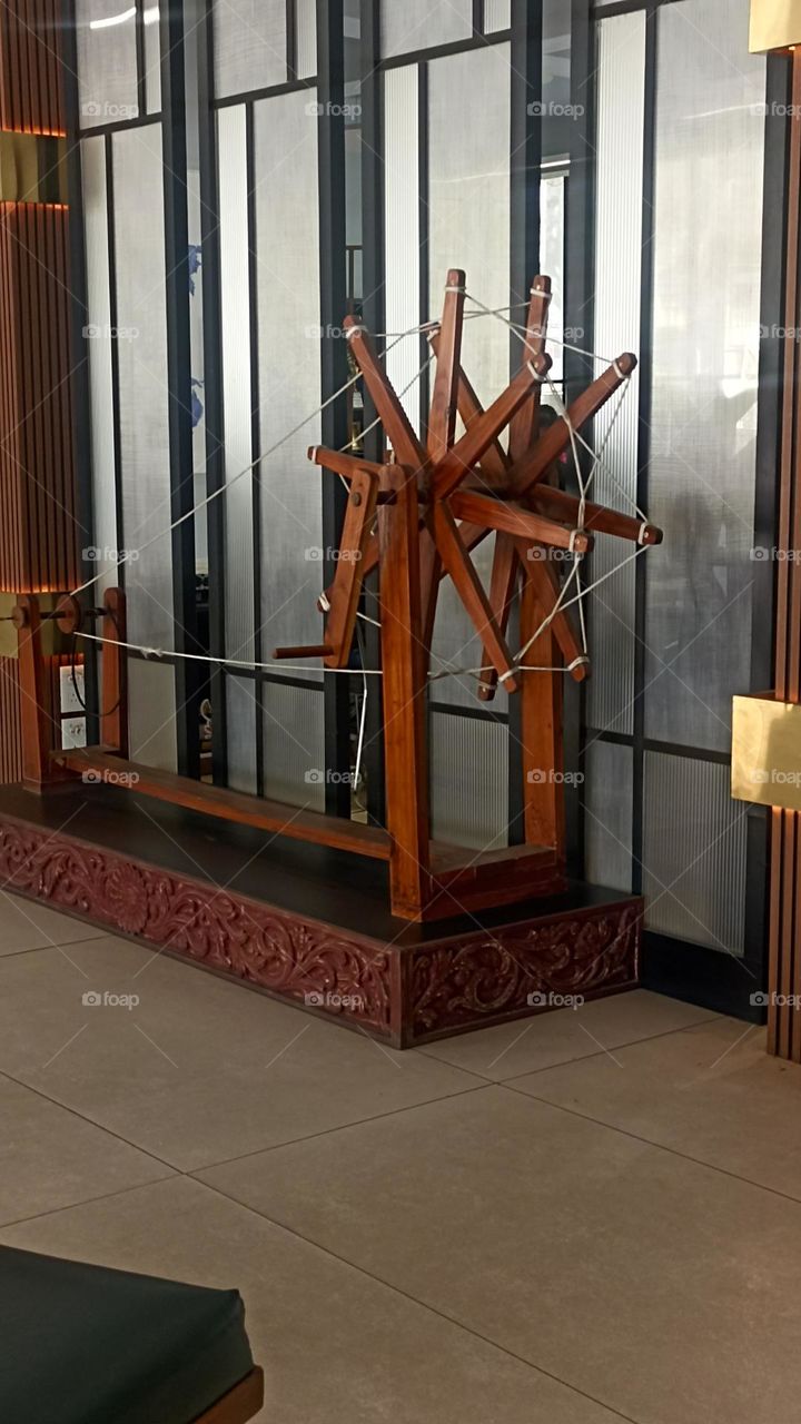 charkha of red wood that has been used by Mahatma Gandhi