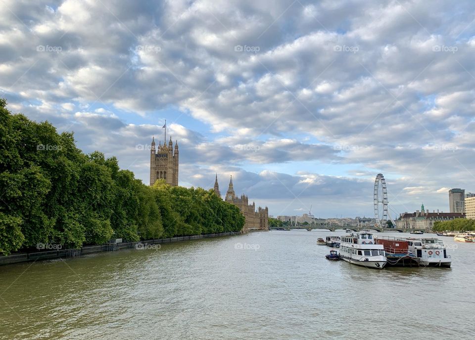 Crossing the river Thames in London, U.K. at Lambeth Bridge with the Houses of Parliament, Big Ben and the London Eye in the distance 