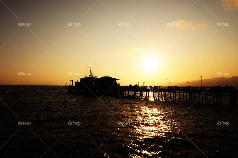 pier silhouette and yellow sunset