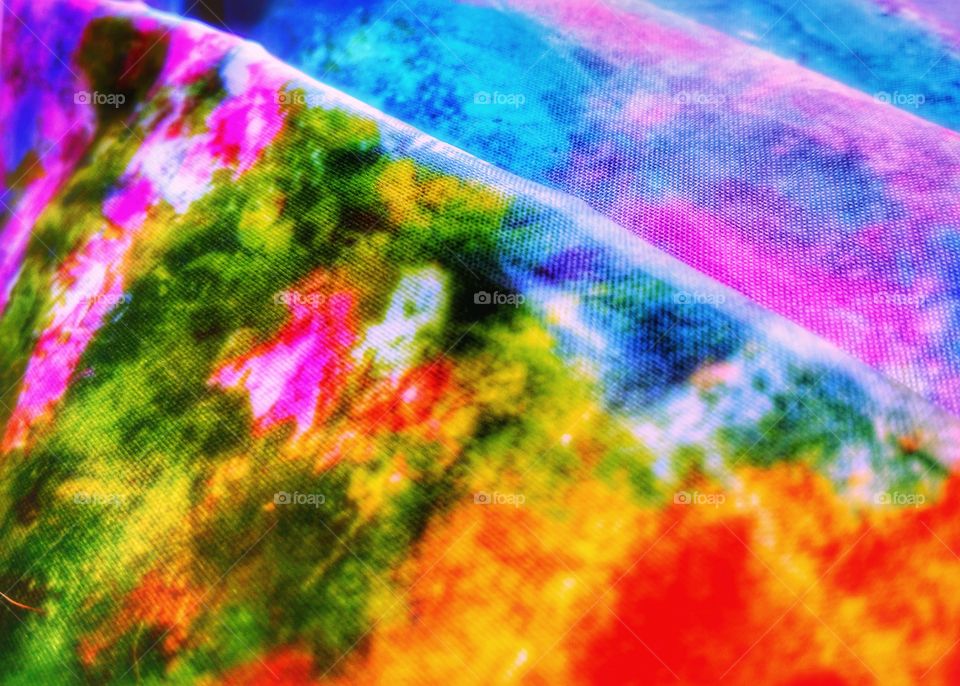 Clash of color from a closeup of a Monet design on an umbrella
