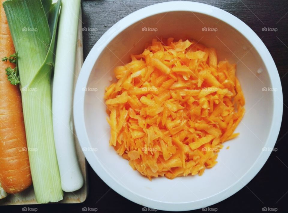 Orange carrot chopped in white bowl