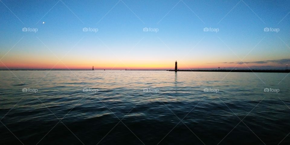 Sunset with the moon and three lighthouses on Lake Michigan in Muskegon , MI ❤